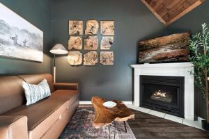 a living room with a couch and a fireplace at Prime Location Upgraded Townhome Hot Tub in Pigeon Forge