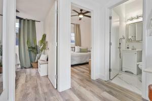 a bathroom with a sink and a bedroom with a bed at Havana Oh Na Na Unit C in Miami