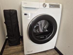 a white washing machine sitting next to a washer at Casa Sallandia met Outdoor Wellness! in Haarle