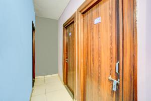 a wooden door with a sign on it in a room at SPOT ON Hotel Heritage Inn in Rājpur +23 photos