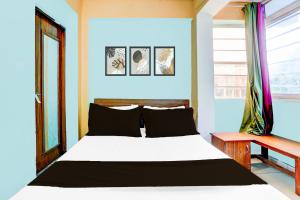 a bedroom with a white bed and a window at SPOT ON Hotel Heritage Inn in Rājpur