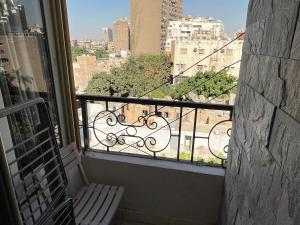 a balcony with a bench and a view of a city at شقة فندقية بالزمالك خلف فندق ام كلثوم اطلالة جانبية على النيل in Cairo