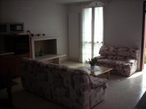 a living room with a couch and a table at B&B Da Toni in Taglio di Po