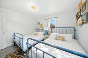 a bedroom with two beds and a window at Liberty Lakefront Home - Pool, Hot Tub, Sauna in Ferndale +41 photos