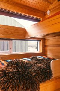 a bed in a room with a large window at Architect Drawn Holiday Home Near Rondane Park in Høvringen