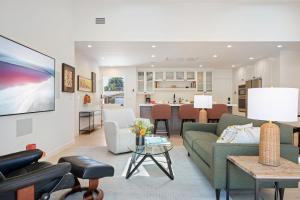 a living room with a couch and a table at Mesa Breeze by Paradise Retreats in Santa Barbara