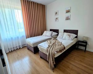 a hotel room with two beds and a window at Apartament w Starym Koszarowcu in Borne Sulinowo