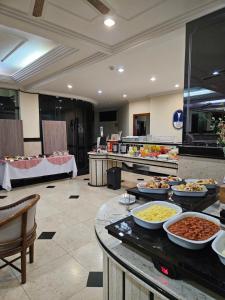 a buffet line with many different types of food at Cristal Palace Hotel in Lins