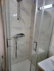 a shower with a glass door next to a sink at Hameau des Essarts in Grand-Couronne +43 photos