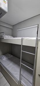 a bunk bed with a ladder in a room at 2201 - Vista mar lateral! Apto para 5 pessoas com ar e vaga in Fortaleza +17 photos