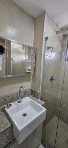 a bathroom with a sink and a shower at 2201 - Vista mar lateral! Apto para 5 pessoas com ar e vaga in Fortaleza
