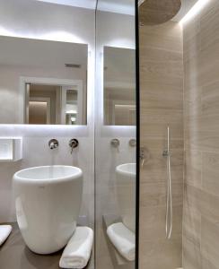 a bathroom with a toilet and a sink and a shower at Hotel Lemik in Alsasua