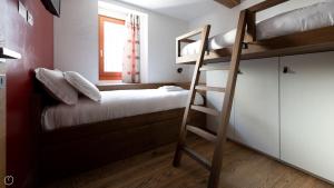 a bedroom with two bunk beds and a ladder at Morcelli 4 - Bajona in Bormio