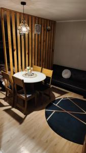 a living room with a table and chairs and a couch at Atakama loft in Caldera