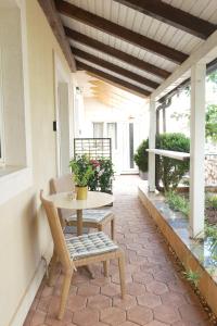 a patio with a table and chairs on a porch at Apartments Coco in Hvar +10 photos
