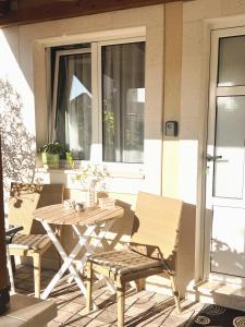 a wooden table and chairs on a patio at Apartments Coco in Hvar