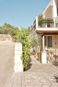 a building with a balcony on the side of it at Apartments Coco in Hvar