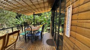 a wooden deck with a table and chairs on it at Casa Islandia in La Vega
