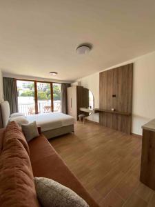 a living room with a couch and a bed at Guesthouse Nesa in Ulcinj