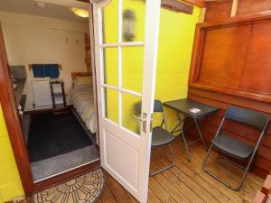 a room with a door and a bed and a table and chairs at Lancaster in Lincoln