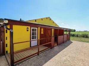 a small yellow and red house with a porch at Lancaster in Lincoln