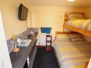 a bedroom with two bunk beds and a sink and a tv at Lancaster in Lincoln