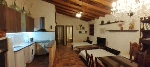 a kitchen with two beds and a table in a room at Vegas de la Alcarria in Horche