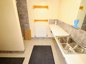 a kitchen with a sink and a tile floor at Dakota in Lincoln