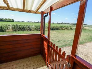 a porch with a chair and a view of a field at Dakota in Lincoln +2 photos