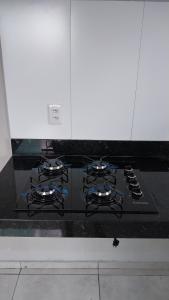 a stove with four burners on a kitchen counter at Casa COP 30 in Belém