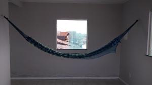 a hammock hanging from a wall in a room at Casa COP 30 in Belém