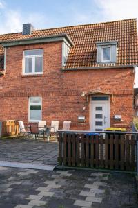 a brick house with chairs and a table in front of it at Ferienwohnung Am Hafen in Bleckede