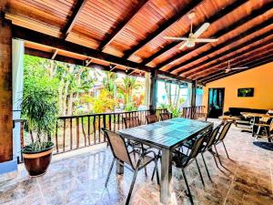 a dining room with a table and chairs on a balcony at Stylish Colorful & Cozy Tropical Private Bedroom in Herradura
