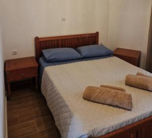 a bedroom with a bed with two pillows on it at Maria House in Kefalos