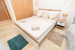 タンジェにあるCocon neuf & cosy 2 ch, clim, wifi, idéal familleの白いシーツと枕が備わったベッドのある寝室