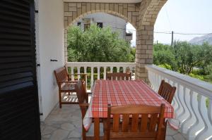 un patio con tavolo e sedie sul balcone. di Apartments Ana a Baška