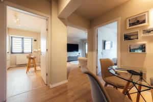 a living room with a table and chairs at Apartament Plaza - Self Check-in in Gura Humorului