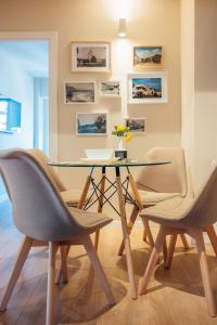 a dining room with a glass table and chairs at Apartament Plaza - Self Check-in in Gura Humorului