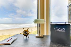 a room with a clock on the floor next to a beach at Romantic Manhattan Beach Sunset #202 in Rockaway Beach