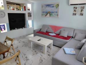 a living room with a couch and a table at Apartment Sandri in Gjilek