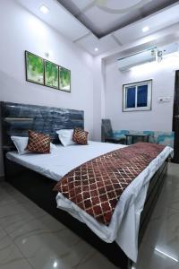 a bedroom with a large bed in a room at Mahadev P Guest House in Varanasi