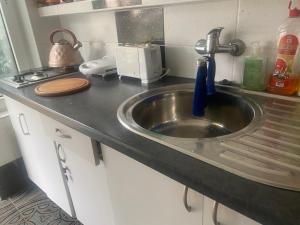 a kitchen counter with a sink in a kitchen at Forum - pensjonat przy plaży in Dźwirzyno