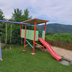 a playground with a slide and a swing at Guest Houses Constantine and Helena Къщи за гости Константин и Елена 