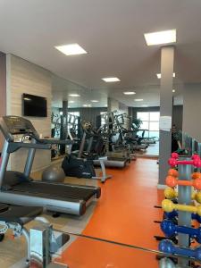 a gym with several treadmills and cardio machines at Flat Premium Vila da Serra in Nova Lima