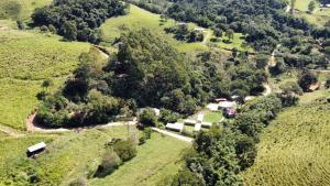 an aerial view of a farm on a hill at Pousada O Bosque in Joanópolis