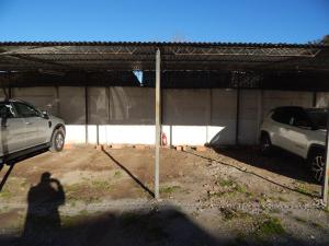 two cars are parked in a parking lot at Departamento Paz in Tandil