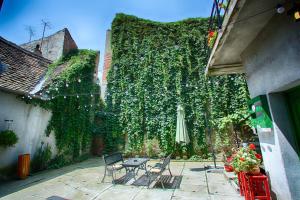 un patio al aire libre con mesa y sombrilla en Goldsmith, en Sibiu