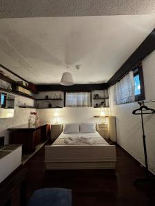 a bedroom with a white bed in a room at Vintage Studio - Great for Travelers in Transit in Koropíon