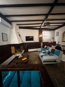 a living room with a couch and a table at Vintage Studio - Great for Travelers in Transit in Koropíon