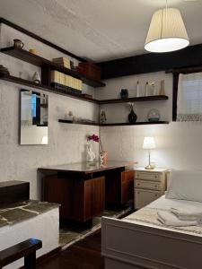 a bedroom with a bed and a desk and a table at Vintage Studio - Great for Travelers in Transit in Koropíon